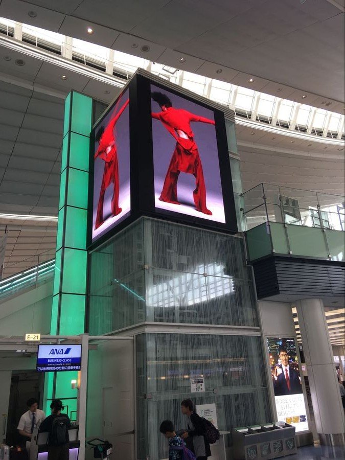 LED display in an airport, two screens joined at a right angle in Japan